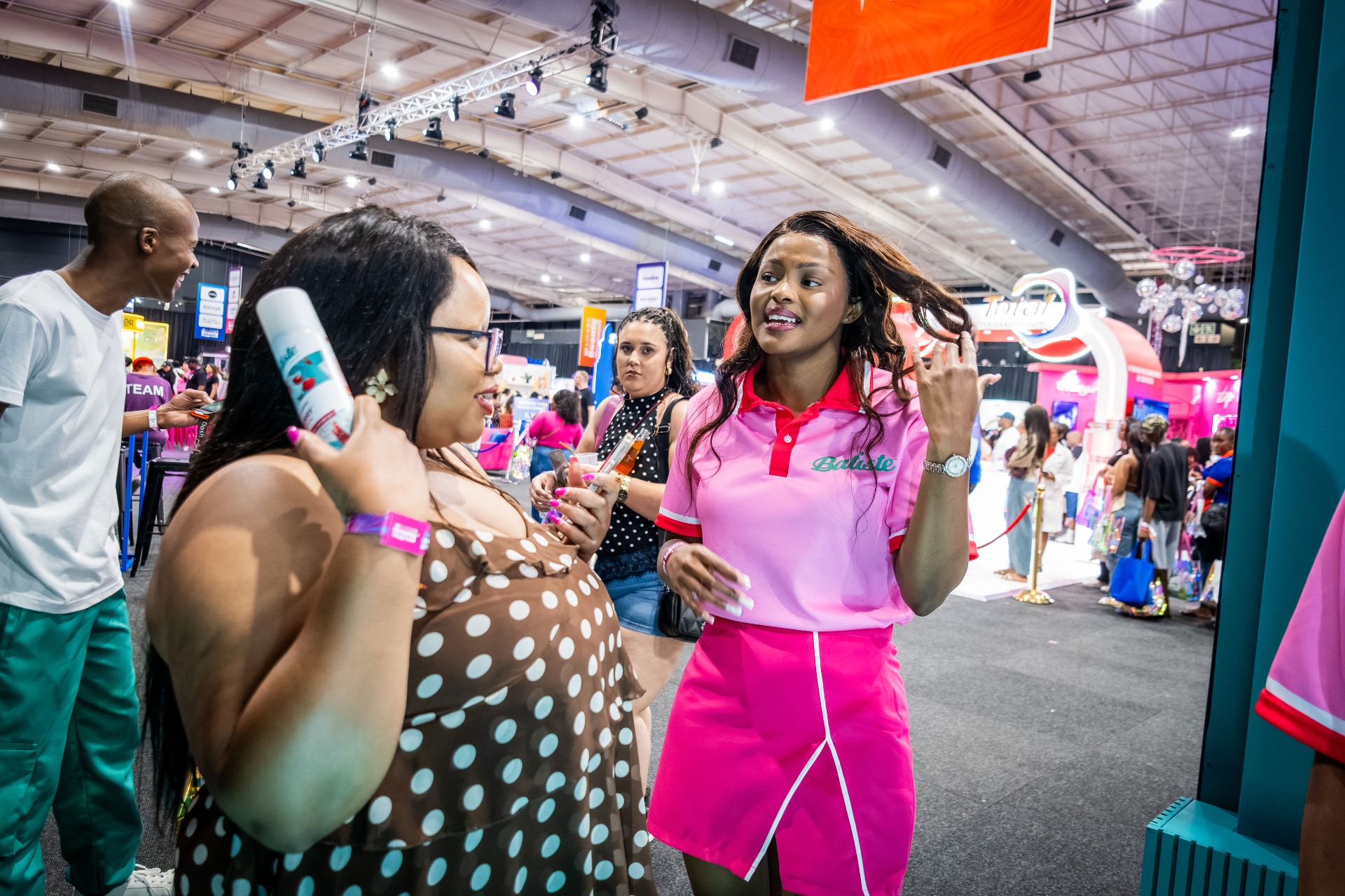 Batiste brand promoter engaging a visitor at a beauty expo